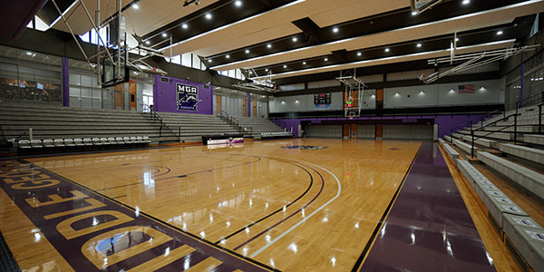 Wide shot of the MGA basketball court on the Cochran campus with bright lights glaring off of the floor.